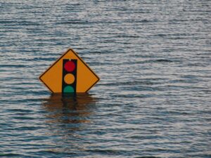 A traffic sign nearly covered by flood waters.